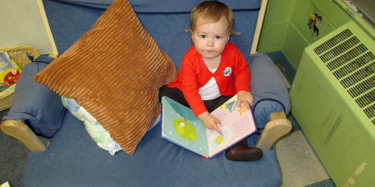 A young toddler with a book