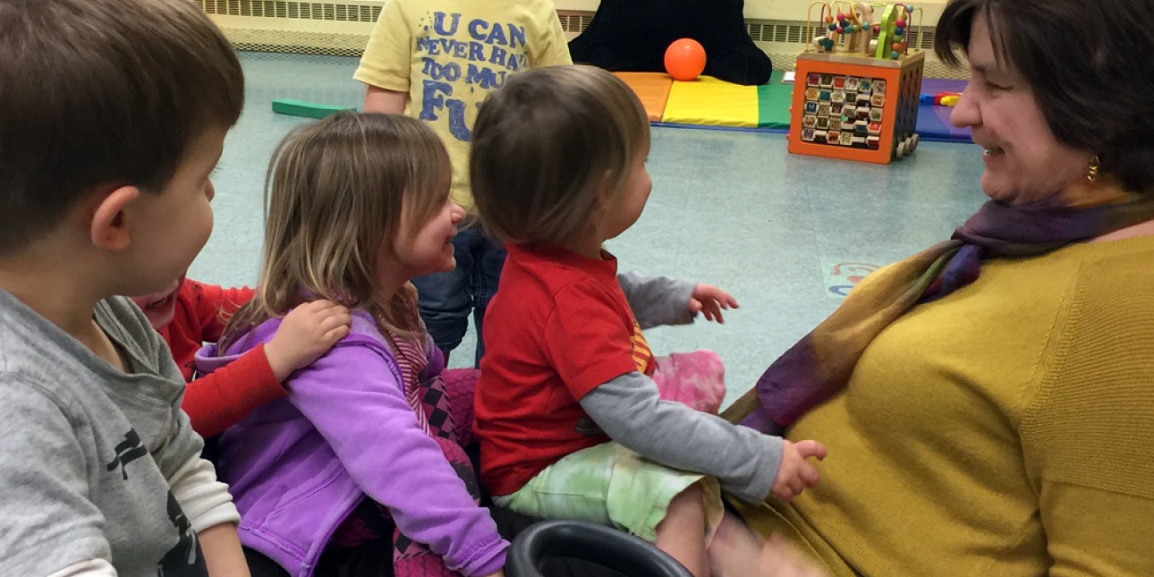 Executive Director Deb Green playing with toddlers